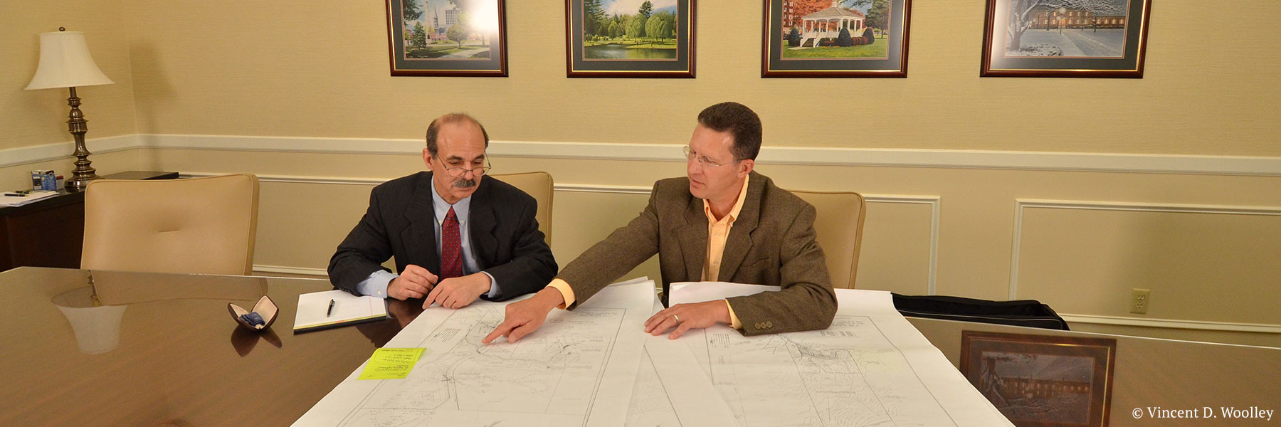 Glens Falls, New York attorney Neil H. Lebowitz in a mock meeting with a client reviewing survey maps. Photographer: Vincent D. Woolley. Copyright owner-licensor: Vincent D. Woolley. Copyright licensee: Neil H. Lebowitz.